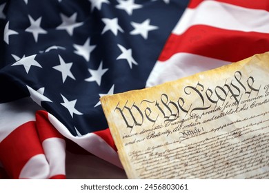 Preamble to the Constitution of the United States and American Flag. Old yellow paper with We The People text - Powered by Shutterstock