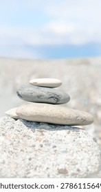 Precarious stone stack representing fragile mental equilibrium amid life turbulence.