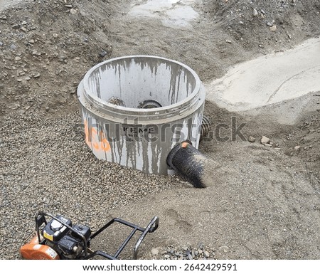 Precast catch basin with two HDPE pipe connections marked 