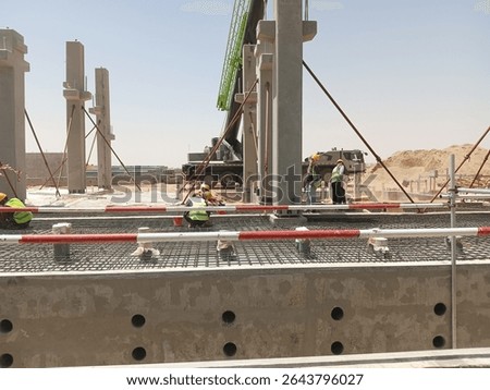 Precast column erection is currently in progress, involving the lifting, positioning, and alignment of precast concrete columns at their designated locations. Cranes and lifting gear are using.