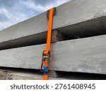 Precast Concrete Load Securing System in Logistics Transportation using orange ratchet tie down straps