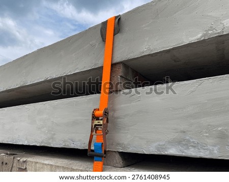 Precast Concrete Load Securing System in Logistics Transportation using orange ratchet tie down straps