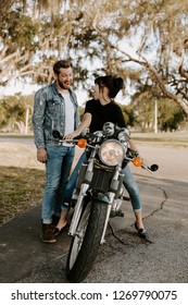 Precious Cute Leisure Lifestyle Portrait Of Handsome Guy And Girl Beauty Being Silly Fun And Laughing While Riding Classic Motorcycle Bike While In Love