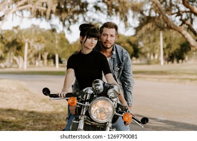 Precious Cute Leisure Lifestyle Portrait Of Handsome Guy And Girl Beauty Being Silly Fun And Laughing While Riding Classic Motorcycle Bike While In Love