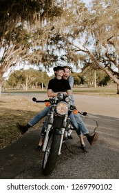 Precious Cute Leisure Lifestyle Portrait Of Handsome Guy And Girl Beauty Being Silly Fun And Laughing While Riding Classic Motorcycle Bike While In Love