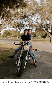 Precious Cute Leisure Lifestyle Portrait Of Handsome Guy And Girl Beauty Being Silly Fun And Laughing While Riding Classic Motorcycle Bike While In Love