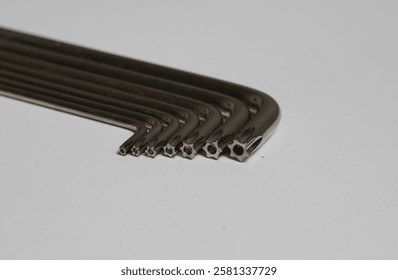 A precise close-up shot of a set of star-shaped Allen keys, also known as Torx keys, neatly arranged on a clean white background