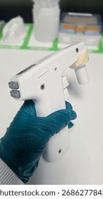 Precise pipettes calibration devise hold by hand in a glove