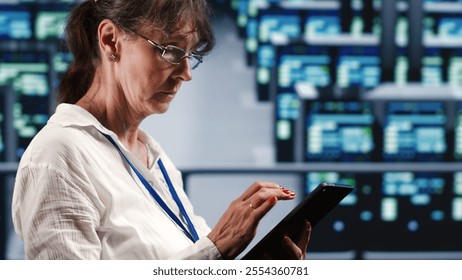 Precise system administrator in data center equipped to handle complex computing operations, doing regular upgrades to server parts, increasing processing power to prevent collapse