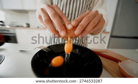 Precise technique shown in bright kitchen during egg cracking