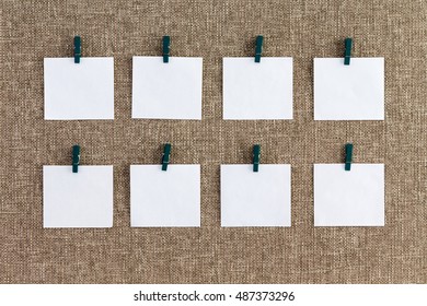 Precisely Aligned Rows Of Blank Memo Pads Hanging From Wooden Clothes Pegs Over A Textured Woven Burlap Background In A Concept Of Organization