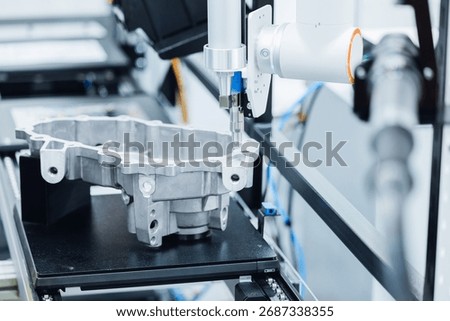 Precision cnc coordinate measuring machine analyzing engine part in high-tech manufacturing conveyor.