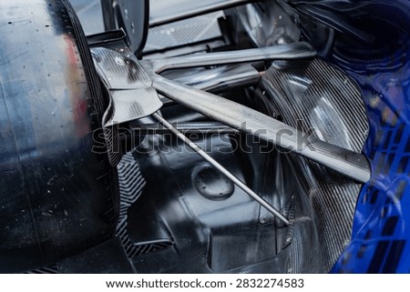 Precision engineering perspective of a formula racing vehicle rear suspension architecture with aerodynamic carbon wishbone links