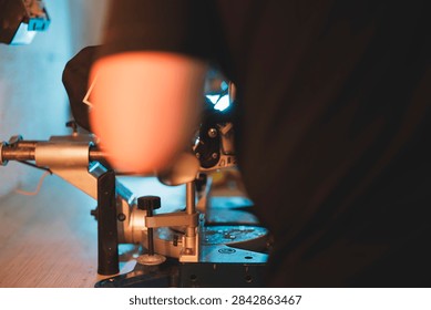 Precision machinery in action with an operator using a tool for detailed work on a manufacturing process in a workshop setting