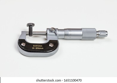 Precision measuring tool – micrometer on a white background. Bolt thread measuring.