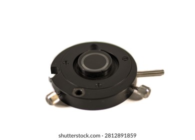 Precision microscope optical filter holder with circular glass filter and adjustment screws, isolated on white background.