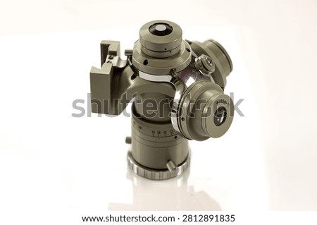 Precision microscope optical head with rotating prism assembly and 15 mm eyepiece lens isolated on a white background.