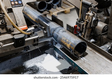 Precision in Motion: A Spark of Engineering Efficiency as an Industrial Machine Grinds Through Steel Pipe