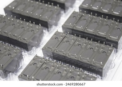 Precision in Multiples: A Grid of Identical Black Electrical Relays Ready for Integration