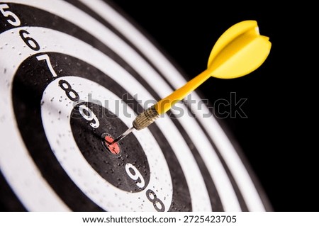 Precision Target: Yellow Arrow Hitting Bullseye on Archery Target in Close-Up Shot