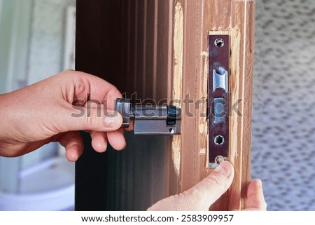 Precision work during installation of mortice sash lock.