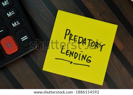 Predatory Lending write on sticky notes isolated on Wooden Table. Business or Finance concept