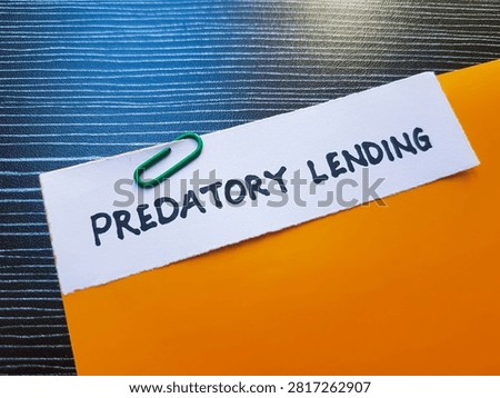 Predatory lending writting on table background. 