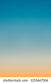 Predawn clear sky and orange horizon   blue atmosphere  Smooth orange blue gradient dawn sky  Background beginning day  Heaven at early morning and copy space  Sunset  sunrise backdrop 