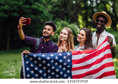 Preety teenagers make a selfie with american flag, celebrating 4th july - Independence Day.
