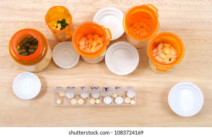 Prefilling once a day medication box with many pills. The importance of medication management cannot be overstated, especially when it comes to the care of seniors. Med boxes assist with management.