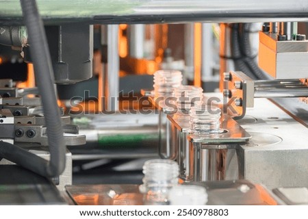  The preform shape between operation of plastic bottle blowing machine. The drinking water bottle manufacturing process by blow mold machine.