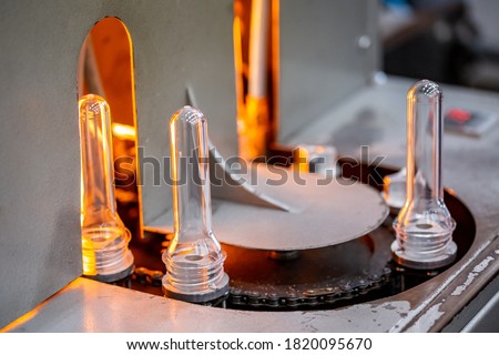 Preforms for making PET plastic bottles. Blank for production of containers for milk or beer. Line factory industry equipment.