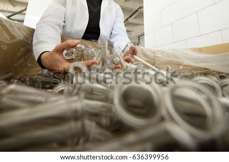Preforms of plastic bottles close-up in hands