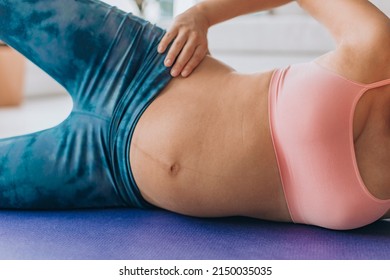 Pregancy Pilates Side Lying Clam Exercise For Pelvic Stability And Hip Muscles Training. Pregnant Woman Working Out On Floor Closeup Of Expecting Belly