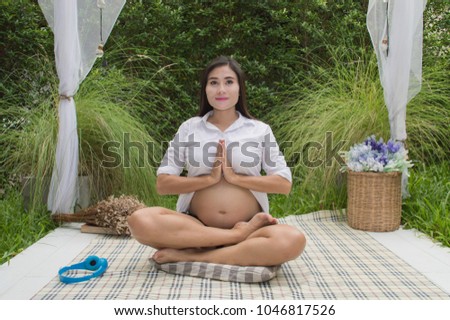 Pregnancy care concept. Pregnant women are exercising with yoga. Beautiful girls are hoping the future of the baby in the womb. Pregnant women are taking care of their health. Stock photo © 