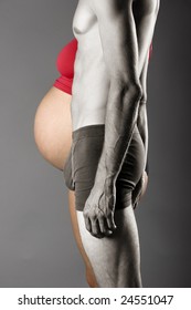 Pregnancy Concept - A Nine Months Pregnant Woman And A Very Skinny Man