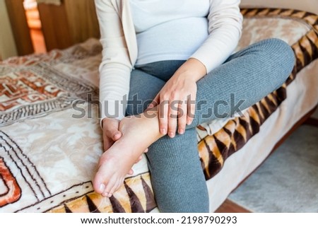 Pregnancy pain leg woman. Pregnant girl have leg disease, ankle pain doing health massage exercise. Foot swelling during pregnancy Foto d'archivio © 