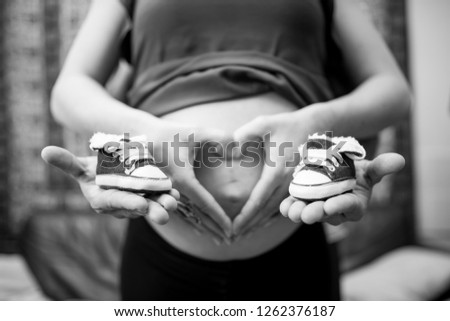 Similar – Image, Stock Photo Baby sneakers held by pregnant