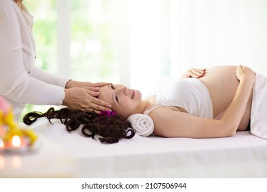 Pregnancy Spa Treatment. Massage For Pregnant Woman. Asian Expectant Mom Enjoying Wellness Day. Relax And Meditation. New Mom Relaxing In Health Care Clinic. Pampering Time For Expecting Mother.