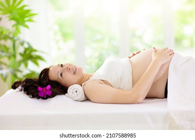 Pregnancy Spa Treatment. Massage For Pregnant Woman. Asian Expectant Mom Enjoying Wellness Day. Relax And Meditation. New Mom Relaxing In Health Care Clinic. Pampering Time For Expecting Mother.