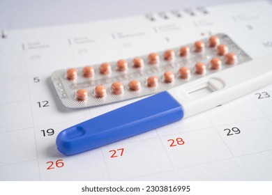 Pregnancy test and birth control pills on calendar, contraception health and medicine. - Powered by Shutterstock