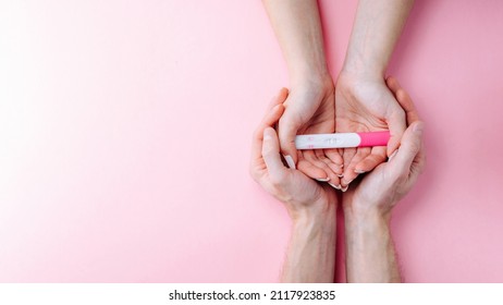 Pregnancy test kit. Female hand hold positive pregnant test with silk ribbon on pink banner background. Medical healthcare gynecological, pregnancy fertility maternity people concept - Shutterstock ID 2117923835