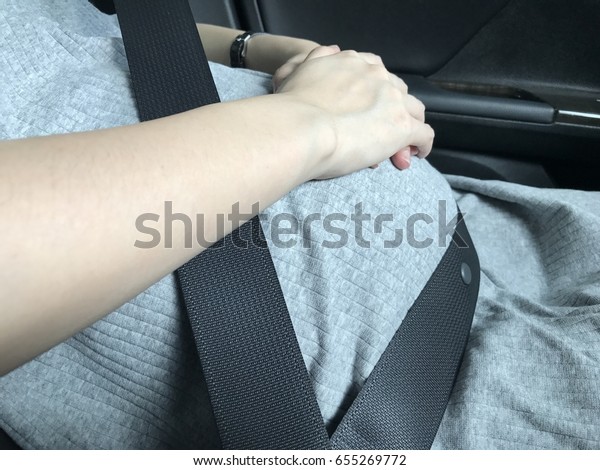 Pregnancy woman in car\
with safety belt.