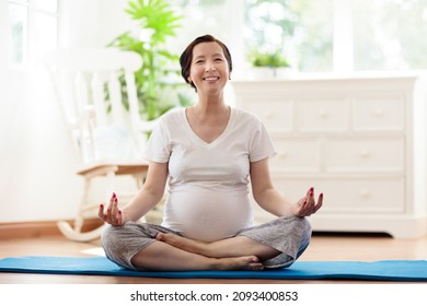 Pregnancy Yoga. Exercise For Pregnant Woman. Active Asian Female Exercising At Home Or Gym. New Expectant Mom Keeping Active And Fit Before Childbirth. Sport For Expecting Mother. Online Class.