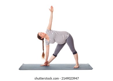 Pregnancy yoga exercise - pregnant woman doing asana Utthita trikonasana - extended triangle pose isolated on white background