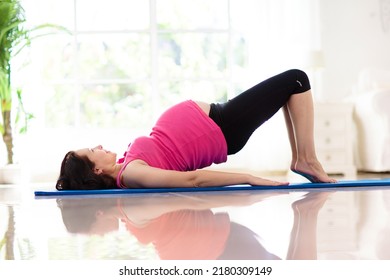 Pregnancy Yoga. Exercise For Pregnant Woman. Active Asian Female Exercising At Home Or Gym. New Expectant Mom Keeping Active And Fit Before Childbirth. Sport For Expecting Mother. Online Class.