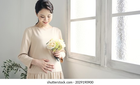 Pregnant Asian Woman Concept. Maternity Photography.