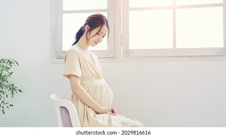 Pregnant Asian Woman Concept. Maternity Photography.