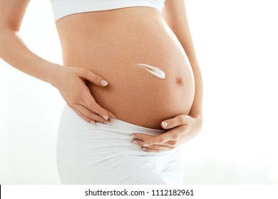 Pregnant Belly Skin Care. Belly With Cream On Skin
