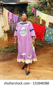 Pregnant Black African Woman In Her Backyard With Clothesline.